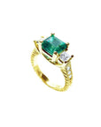 18K yellow gold ring with a large emerald cut emerald and princess cut side diamonds, antique decor.