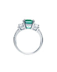 1.88 carat emerald ring with side emerald-cut diamonds and round accents in 18k white gold.