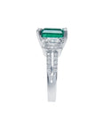 1.88 carat emerald ring with side emerald-cut diamonds and round diamonds set in 18k white gold.