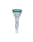 1.88 carat emerald ring with side emerald-cut diamonds and round diamonds set in 18k white gold.