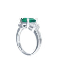 1.88 carat emerald ring with side emerald-cut and round diamonds in 18k white gold.