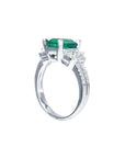 1.88 carat emerald ring with side emerald-cut and round diamonds in 18k white gold.