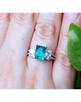 Natural colombian emerald and side emeral-cut genuine diamonds engagement ring.