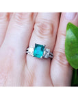 Natural colombian emerald and side emeral-cut genuine diamonds engagement ring.
