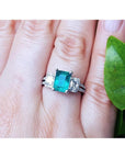 Natural colombian emerald and side emeral-cut genuine diamonds engagement ring.