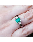 1.38 ct. Colombian emerald ring with two princess cut side diamonds in 18k white gold.