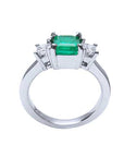 A white gold emerald and diamond ring with the top, gallery and band lateral profile view.