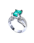 Emerald-cut Colombian emerald ring in 18K white gold with diamond accents.