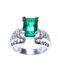 An emerald ring for women emerald-cut in 18k white gold, with accent natural diamonds.