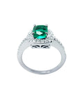 Women's 1.19 ct cushion cut emerald ring in 14K white gold with diamond halo and band.