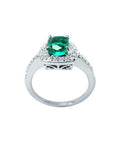 Women's 1.19 ct cushion cut emerald ring in 14K white gold with diamond halo and band.