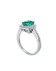 Women's 14K white gold ring with a cushion-cut emerald and diamond halo.