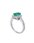 Women's 14K white gold ring with a cushion-cut emerald and diamond halo.