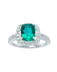 This cushion cut emerald ring for women is adorned with natural diamonds encircling the emerald in white gold