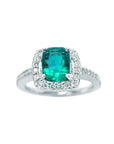 This cushion cut emerald ring for women is adorned with natural diamonds encircling the emerald in white gold