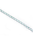 14K white gold bracelet with round Colombian emeralds bezel-set in diamond-shaped links.