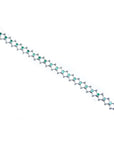 14K white gold bracelet with round Colombian emeralds bezel-set in diamond-shaped links.