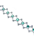 14K white gold bracelet with round cut Colombian emeralds bezel set in diamond-shaped links.
