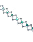14K white gold bracelet with round cut Colombian emeralds bezel set in diamond-shaped links.