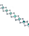 14K white gold bracelet with round cut Colombian emeralds bezel set in diamond-shaped links.