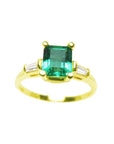 Topside view of a emerald-cut with side baguettes diamond ring in yellow gold.