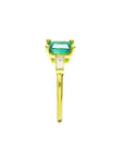 This yellow gold emerald ring shows its side profile, on top the square emerald, baguette diamond and band ring downside.