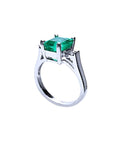 1.56 ct emerald ring with princess-cut side diamonds in 14K white gold.