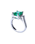 Showcasing the top emerald setting, gallery, and band of a Colombian emerald ring.