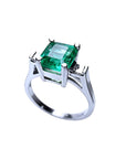 1.56 ct. bluish-green emerald ring with princess-cut side diamonds in 14K white gold.