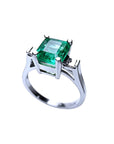 1.56 ct. bluish-green emerald ring with princess-cut side diamonds in 14K white gold.