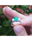 1.62 carat emerald engagement ring with side princess cut diamonds in 14k white gold.
