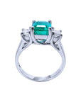 A natural emerald and diamond side princess cut ring on a lateral position, top and gallery profile view.