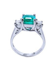 1.62 carat emerald engagement ring with side princess cut diamonds in 14k white gold.