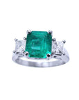 Natural colombian emerald and side princess cut diamonds three stone ring in 14k white gold.