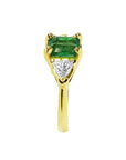 1.51 ct. emerald and trillion-cut diamonds ring in 18k yellow gold.
