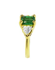 1.51 ct. emerald and trillion-cut diamonds ring in 18k yellow gold.