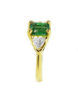 1.51 ct. emerald and trillion-cut diamonds ring in 18k yellow gold.