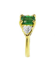 1.51 ct. emerald and trillion-cut diamonds ring in 18k yellow gold.