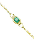 A square natural colombian emerald solitaire bracelet prong set in 14k yellow gold.