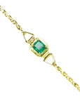 A square natural colombian emerald solitaire bracelet prong set in 14k yellow gold.