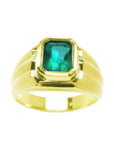 A 14k yellow gold men's natural colombian emerald solitaire ring bezel set.
