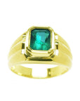A 14k yellow gold men's natural colombian emerald solitaire ring bezel set.