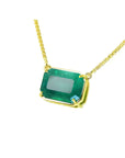 Emerald-cut Colombian emerald solitaire necklace in 18K yellow gold.