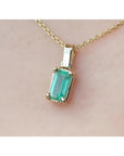 1.31 ct emerald solitaire pendant in 14K yellow gold, featuring a vibrant green emerald.