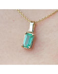 1.31 ct emerald solitaire pendant in 14K yellow gold, featuring a vibrant green emerald.