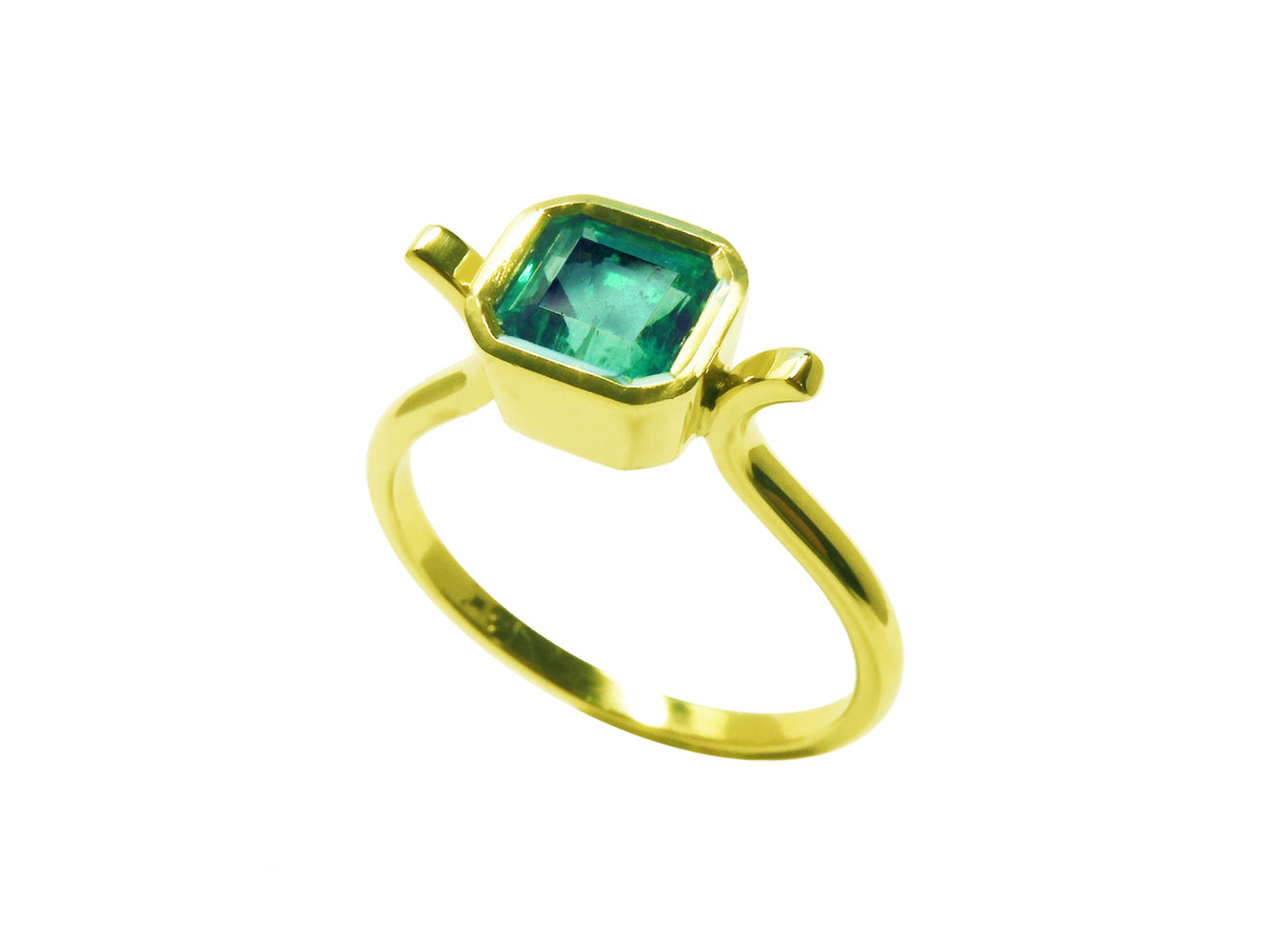 Top and side perspective of a solitaire emerald ring bezel set in yellow gold