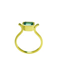 0.81 ct. emerald solitaire ring, bezel set in 14K yellow gold with a unique open shank design.