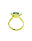 0.81 ct. emerald solitaire ring, bezel set in 14K yellow gold with a unique open shank design.