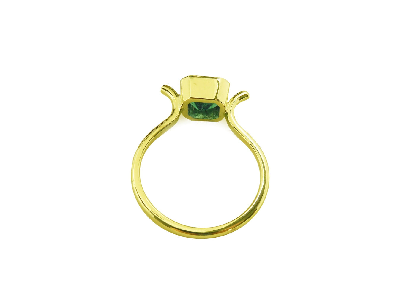 Displaying the underside view of a solitaire emerald ring bezel set in yellow gold
