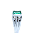 Men's 18K white gold solitaire ring with a bezel-set, rectangular Muzo emerald.